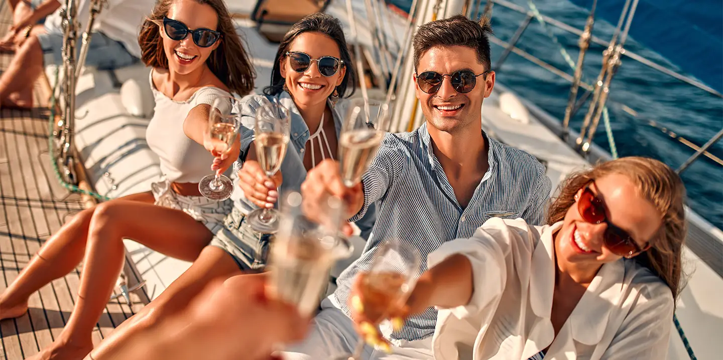 Yacht party charter in Dubai with guests celebrating on deck